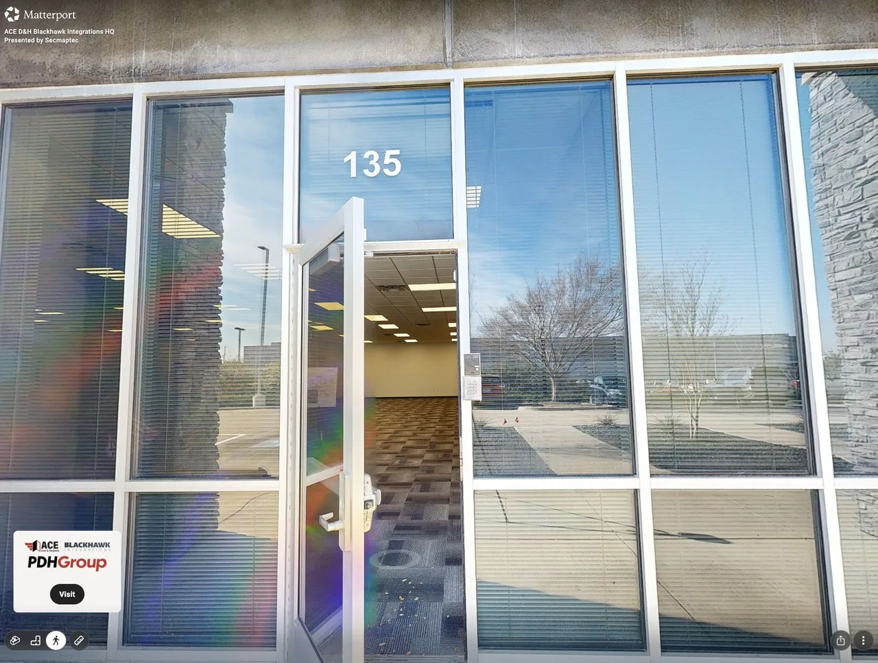 Matterport capture of the glazed office entrance with a view into the open workspace